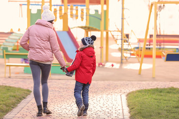 Woman with little boy outdoors. Child adoption