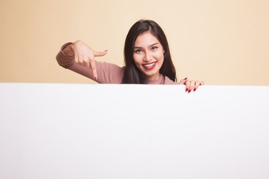 Young Asian woman with blank sign.