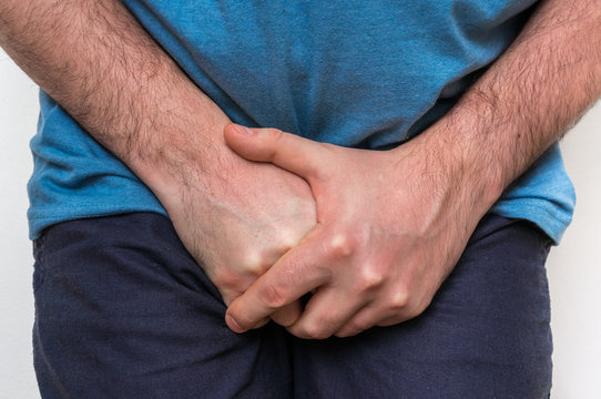 Man with incontinence problem is holding his crotch