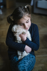 little boy lying with white dog