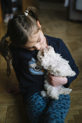 little boy lying with white dog