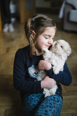 little boy lying with white dog