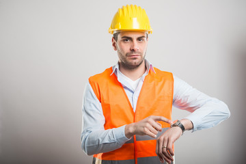 Portrait of young architect showing wrist watch