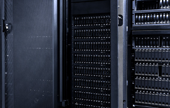 Dark server room data center storage with with open door of mainframe