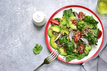 Vegetable sald with avocado, baby spinach, tomato and buckwheat.Top view.