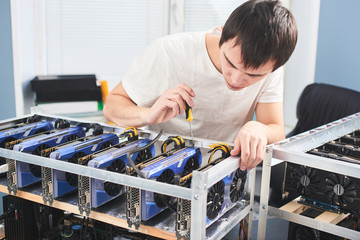 A young man sets up a farm for the extraction of cryptocurrency