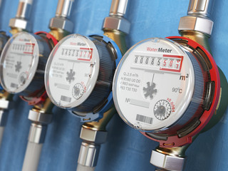 Row of water meters of cold and hot water on the wall background.