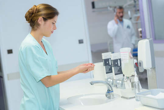 young beautiful nurse washes hands