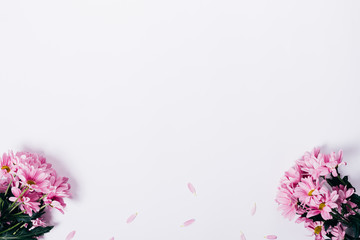 Lilac flowers and petals on a white table