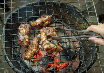 Grilled pork bone on charcoal stove