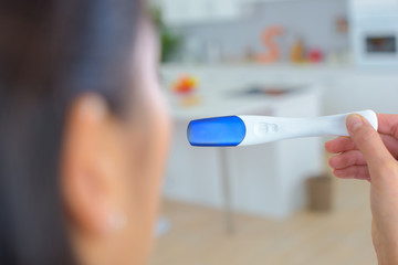 close up of woman hand holding a pregnancy test