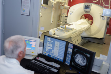 MRI technician surveying the process