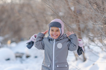 Cute child playing with snow