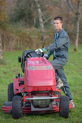 Fototapeta premium Young man stepping on to mower