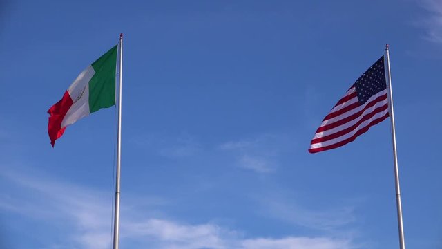 The Mexican flag flies beside the American flag along the US border in Tijuana.
