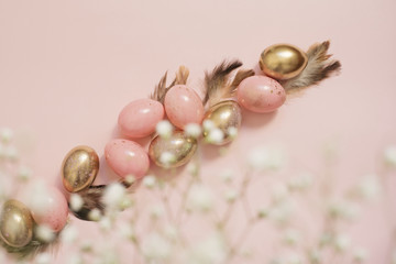 Pink and Gold Easter Eggs. Pastel Easter Concept with Eggs, Flowers and Feathers. Punchy Pastels
