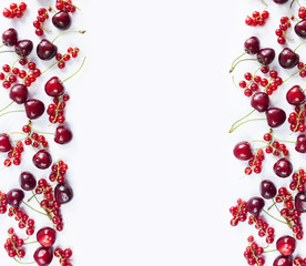 Ripe red currants and cherries. Berries at border of image with copy space for text. Background berries. Top view.