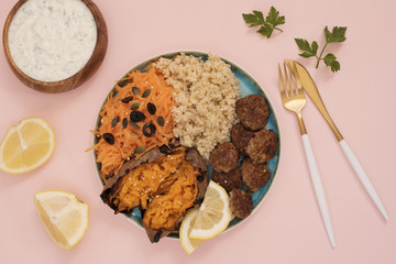 Healthy food concept. Clean eating. Meal with turkey meatballs, bulgur, sweet potato, carrot, salad. Pink and gold concept. Low carb eating, light lunch, fitness menu