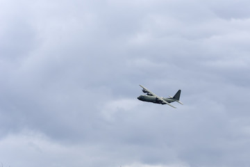 A military aircraft flying through the Scottish Highlands at speed