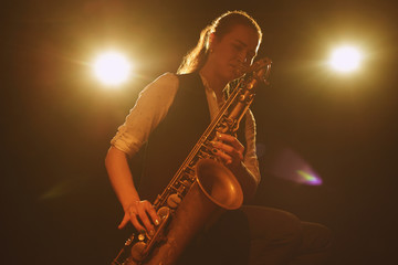 The girl playing the saxophone
