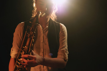 The girl playing the saxophone