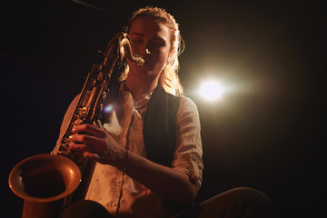 The girl playing the saxophone
