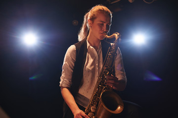 The girl playing the saxophone
