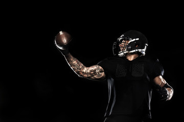 American football sportsman player isolated on black background