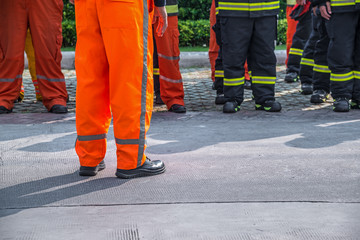 fireman standing in row with fire fighting protection suit and equipment standby for operation