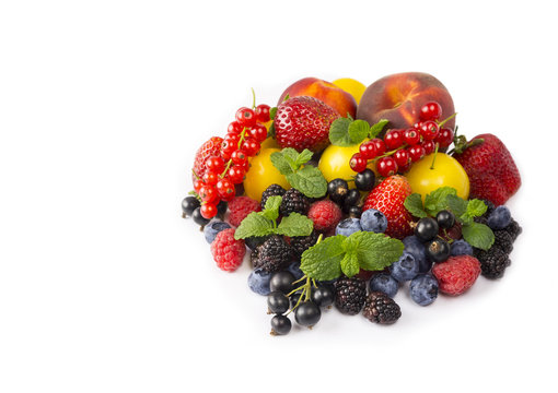 Fruits and berries isolated on white background. Ripe currants, strawberries, blackberries, bluberries, peaches and yellow plums. Sweet and juicy fruits with copy space for text.