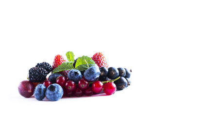 Fruits and berries isolated on white background. Ripe currants, blackberries, blueberries and strawberries with mint.  Background of mix fruits on a white background. Top view.