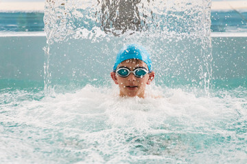 GRODNO, Belarus - Health resort Porechye. A boy is swimming in a pool in a waterfall.