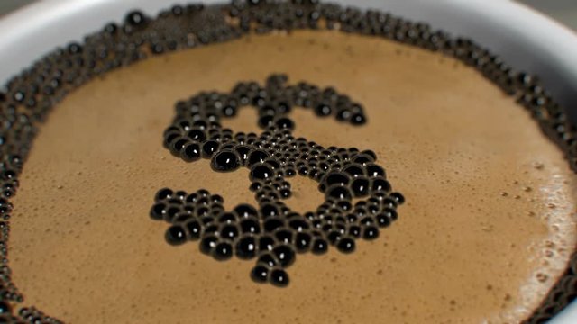 Animation of coffee bubbles popping to form a Dollar Sign in a frothy cup of coffee. Macro shot with depth of field.