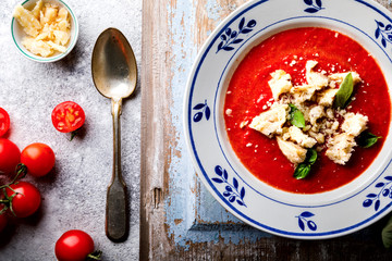 Tomato soup  and fresh tomatoes cherry  on a wooden background Gazpacho