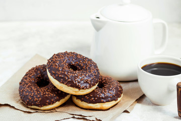 Chocolate donuts and coffee , weekend morning table breakfast. Vintage colors.