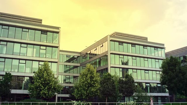 Person walking past a modern office block