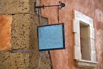 Colored and ancient walls with empty sign display.