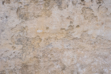 Stone surface of a dark yellow sandstone - background, texture