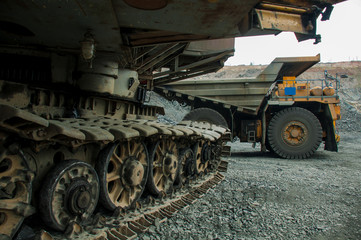 Chassis of the excavator in the background of a dumper in an ore quarry