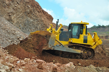 Bulldozer operation in the ore quarry. Clearing the embankment with a bucket.