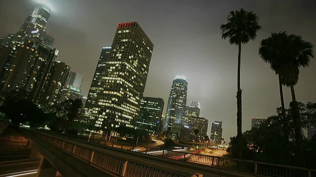 Excellent shot of heavy traffic driving on a busy freeway in downtown Los Angeles at night.
