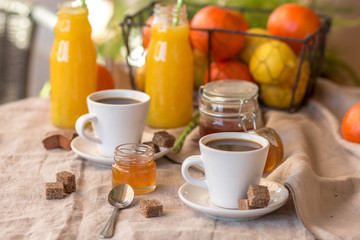 Breakfast with coffee cups, orange juice, cake