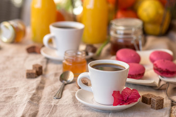 Breakfast with coffee cups, orange juice, cake