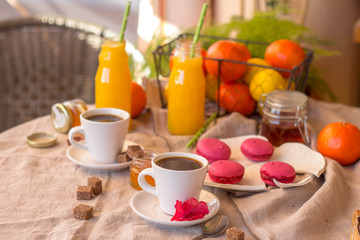 Breakfast with coffee cups, orange juice, cake