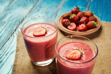 healthy strawberry yogurt with fresh berries on old wooden background