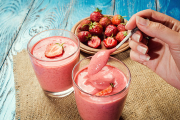 healthy strawberry yogurt with fresh berries on old wooden background