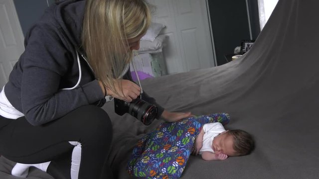 photographer comforts newborn baby during photoshoot
