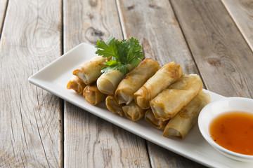 Lumpia Spring Rolls on Wooden Table in Restaurant