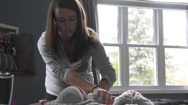 mother comforts her baby using finger as soother