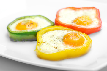 Fried eggs in colorful peppers